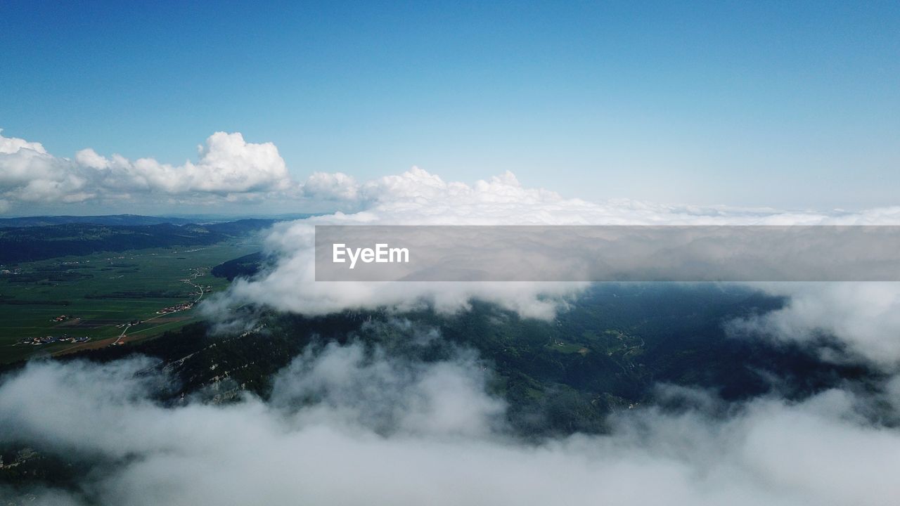 Aerial view of clouds over landscape against sky