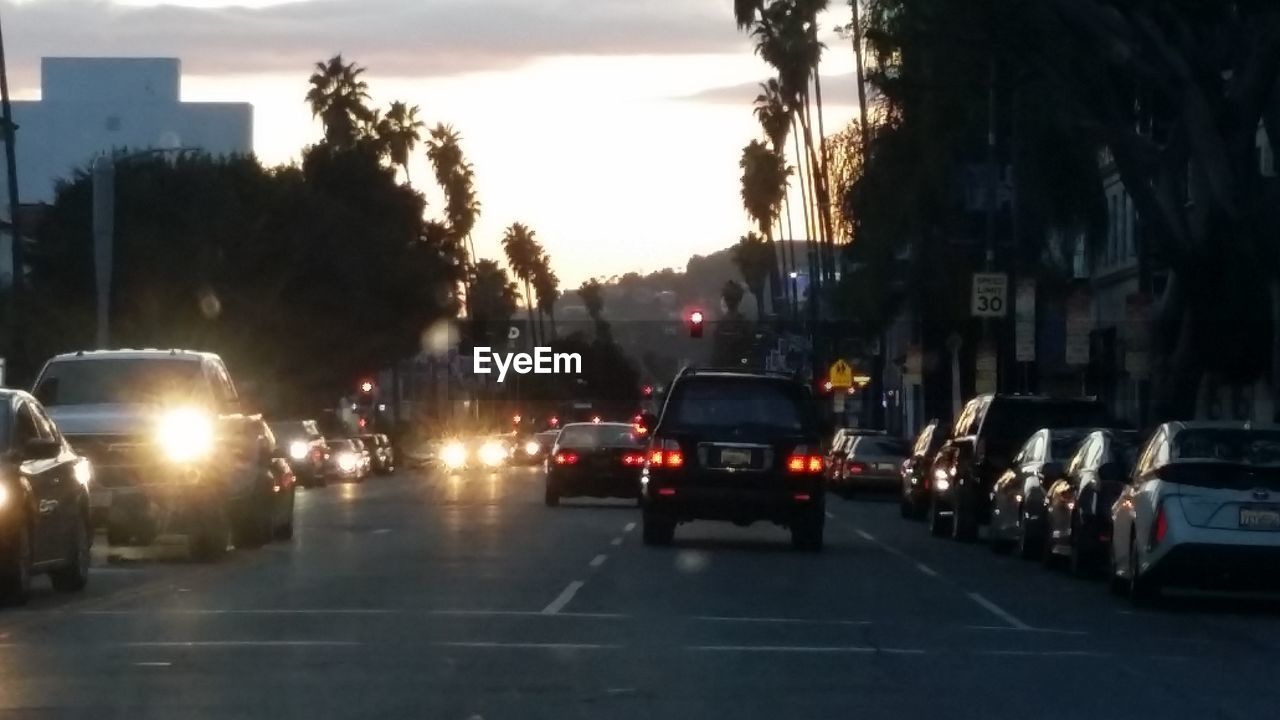 VEHICLES ON ROAD IN CITY AT NIGHT