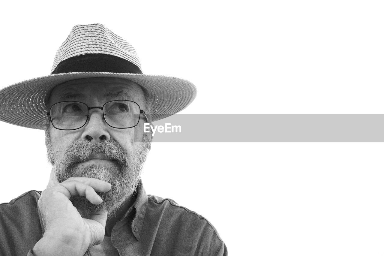 hat, adult, portrait, one person, senior adult, clothing, men, copy space, headshot, facial hair, fedora, person, white background, sun hat, eyeglasses, glasses, looking, moustache, beard, fashion accessory, human face, cut out, front view, contemplation, black and white, lifestyles, emotion, studio shot, casual clothing, looking at camera, cowboy hat, seniors, relaxation, facial expression, cap