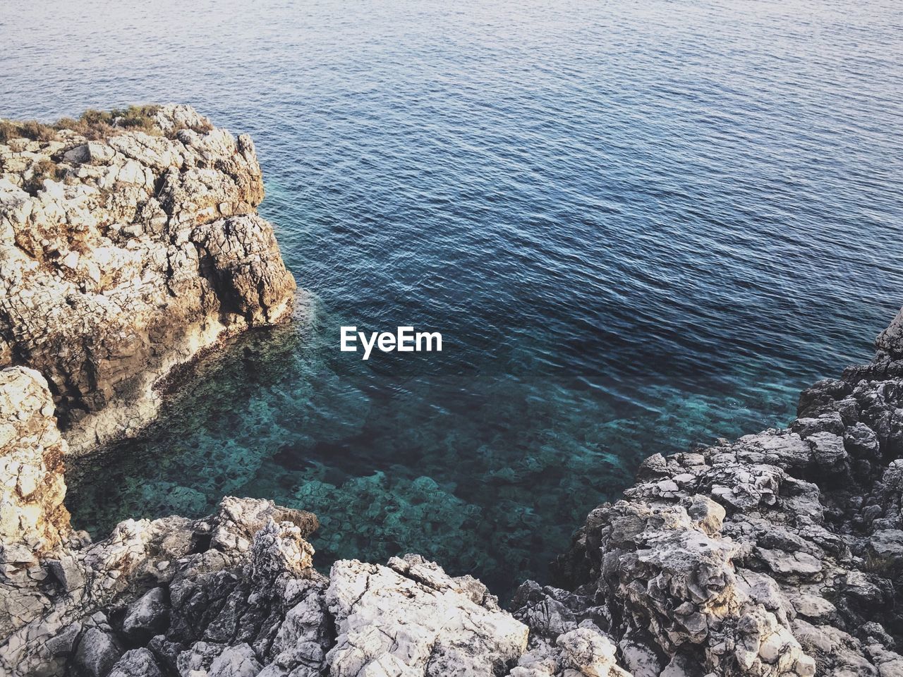 High angle view of sea by rocks