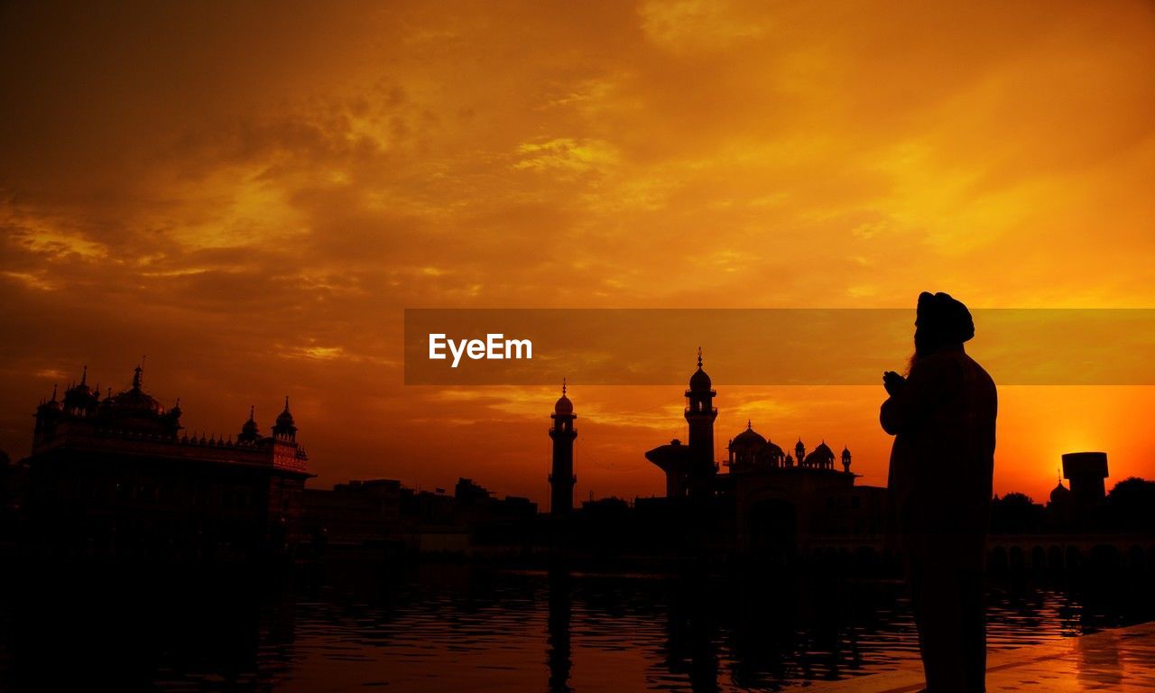sunset, sky, architecture, silhouette, water, built structure, evening, travel destinations, reflection, dawn, building exterior, nature, religion, city, cloud, afterglow, orange color, travel, building, horizon, belief, place of worship, spirituality, beauty in nature, history, tourism, sun, the past, outdoors, lake, temple - building, landscape, tower, nautical vessel, skyline, twilight, tranquility