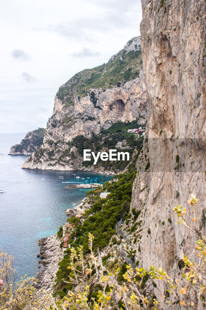 Scenic view of sea and mountains against sky