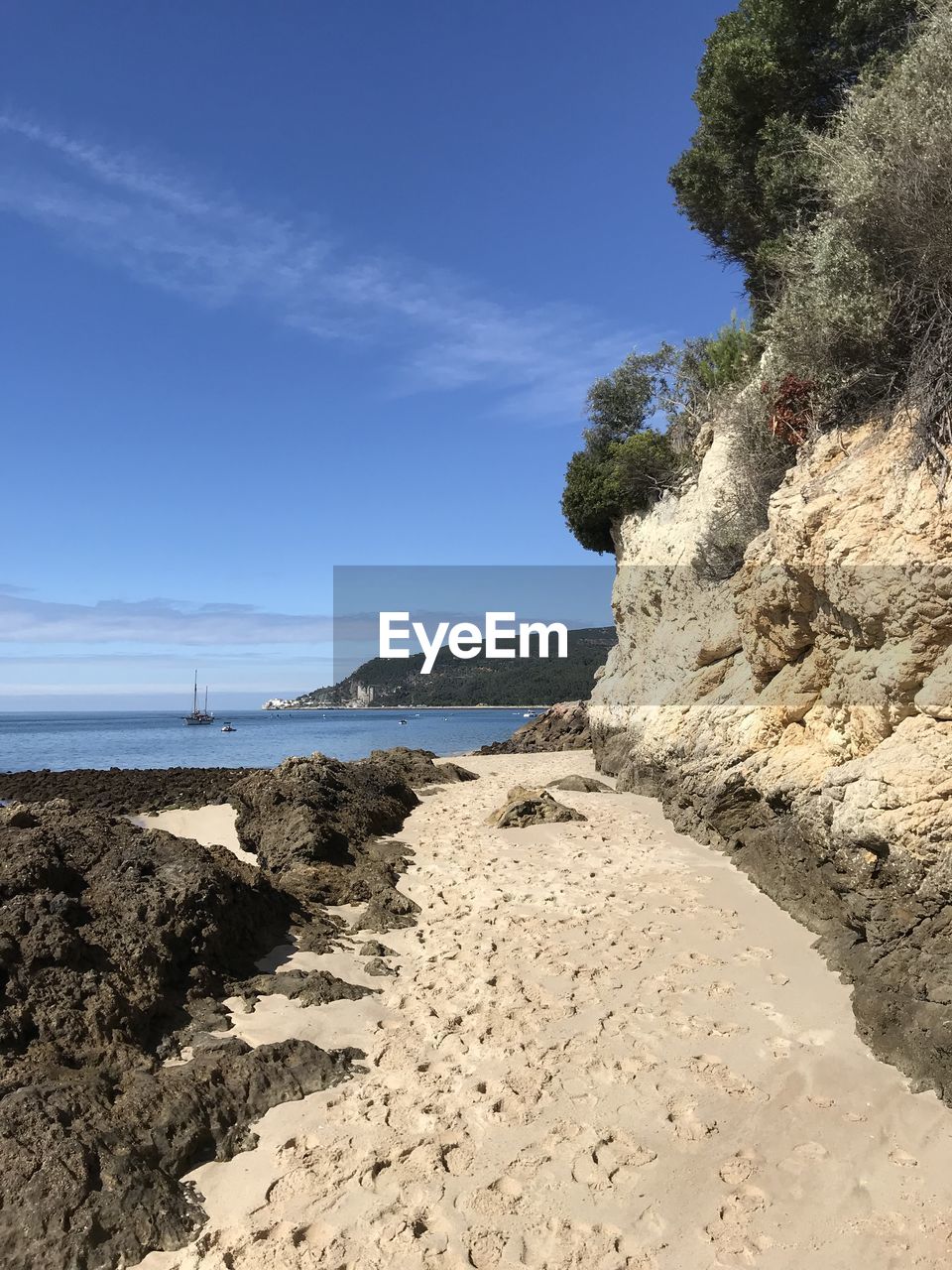 Scenic view of beach against blue sky