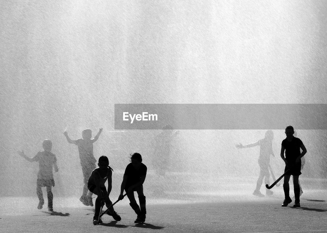 Young hockey players in action during  rain downpour