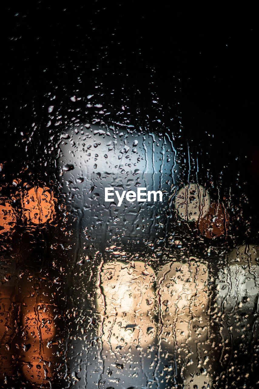 Lights seen through wet windshield at night