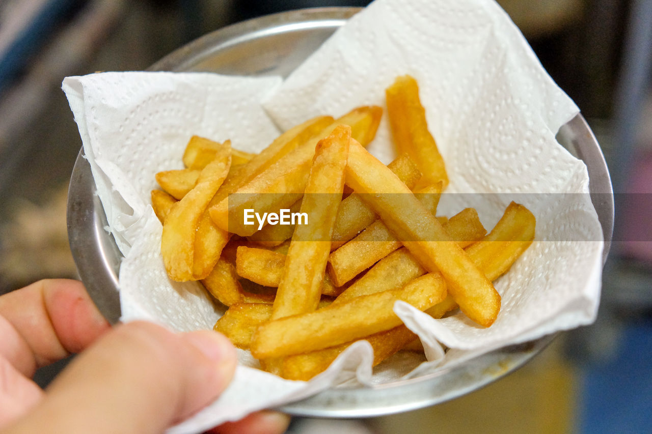 Cropped image of person holding burger