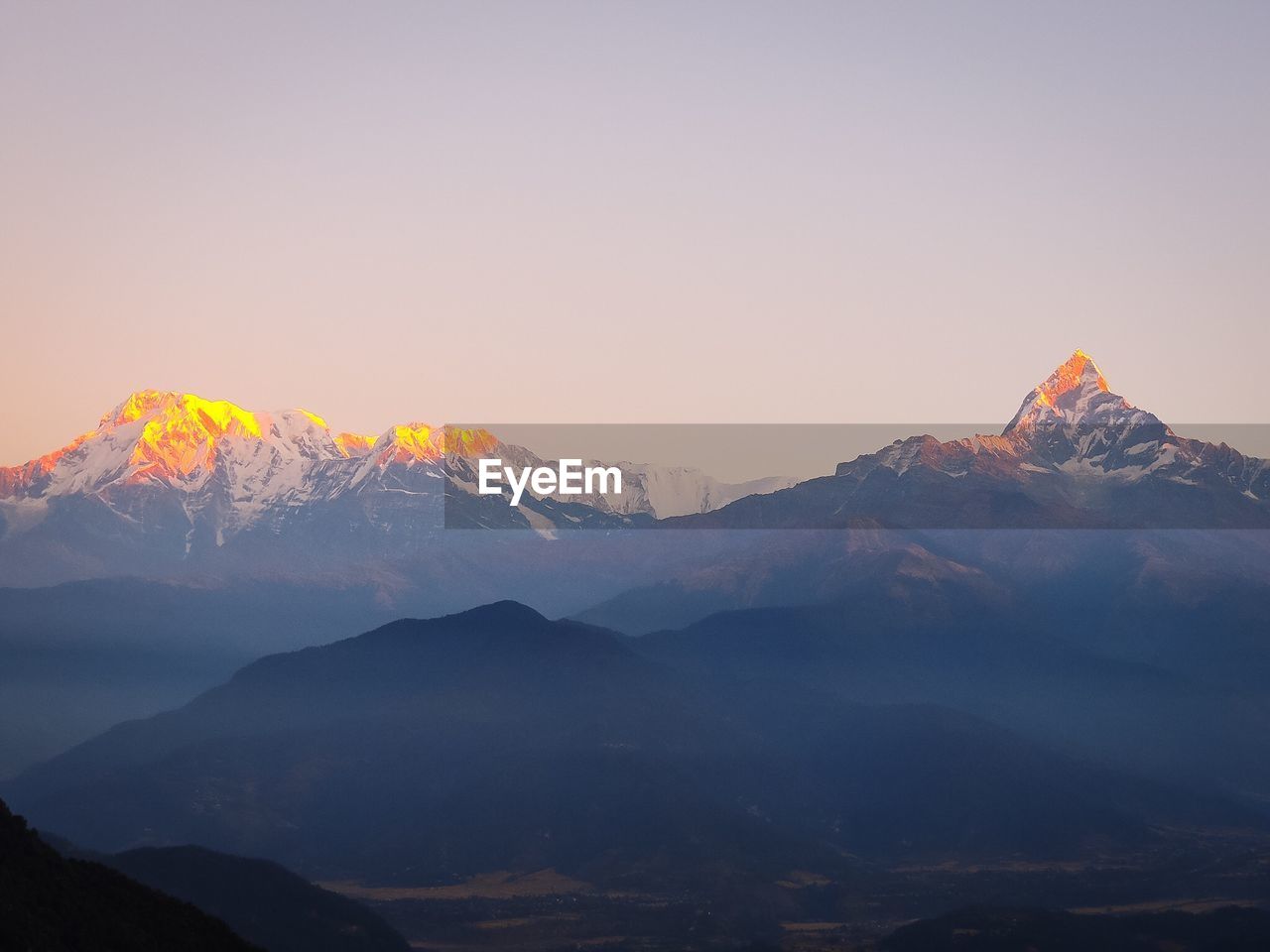 Scenic view of mountains against clear sky during winter