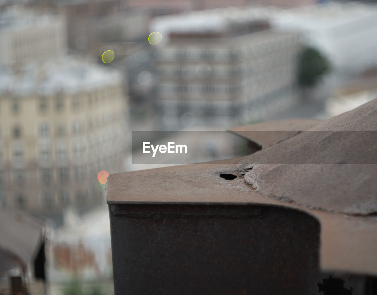 CLOSE-UP OF BALL ON METAL STRUCTURE IN CITY