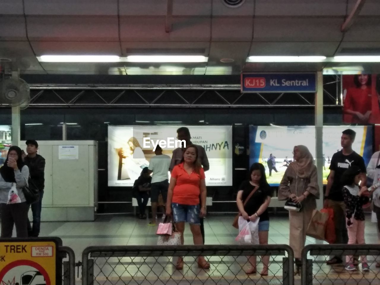 PEOPLE STANDING AT SUBWAY STATION