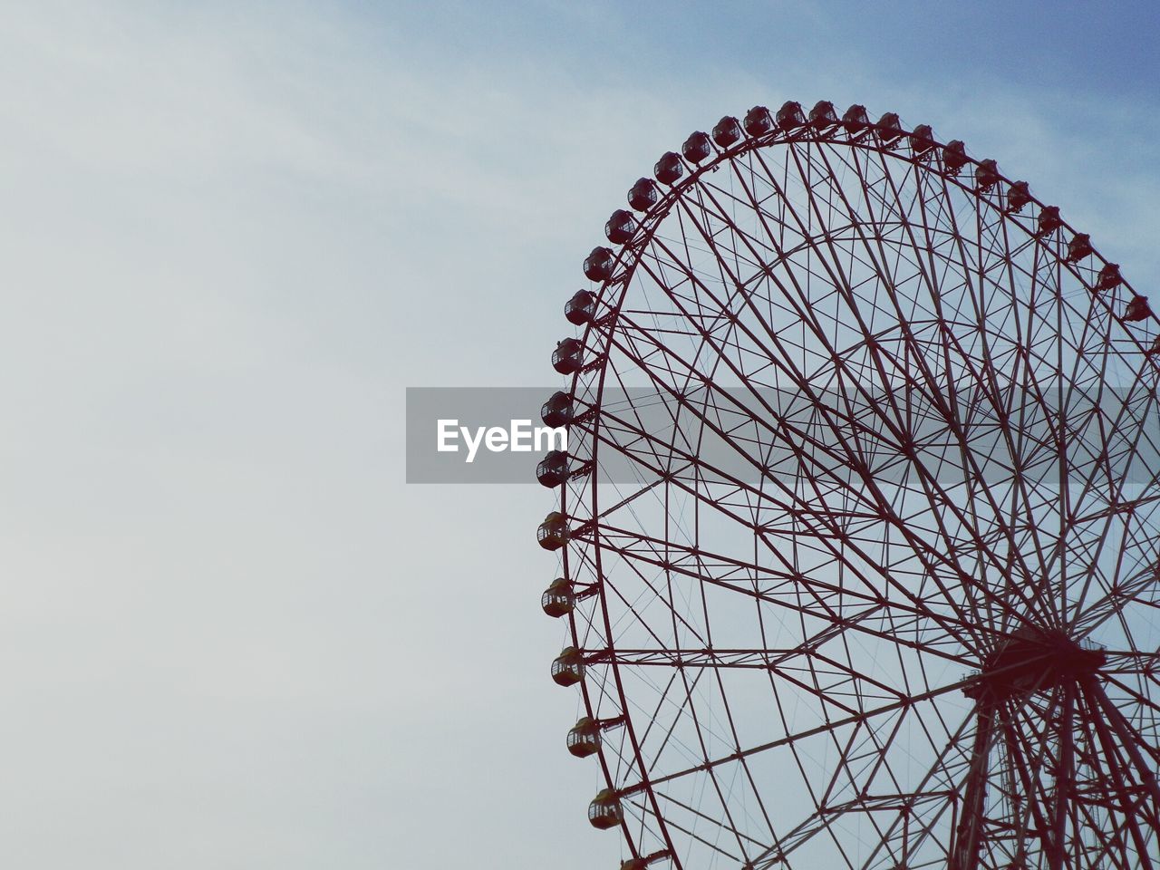 LOW ANGLE VIEW OF FERRIS WHEEL AT NIGHT