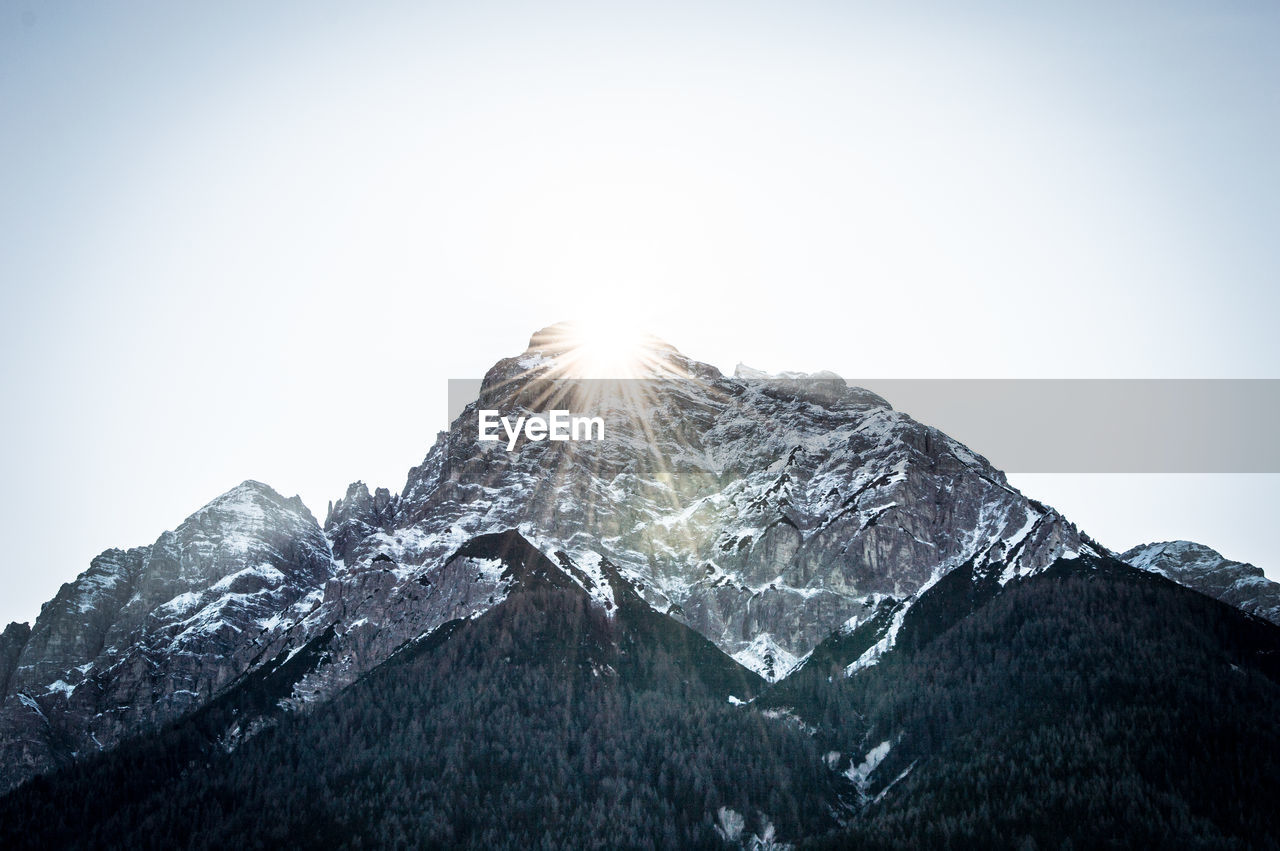 Scenic view of snowcapped mountains against clear sky