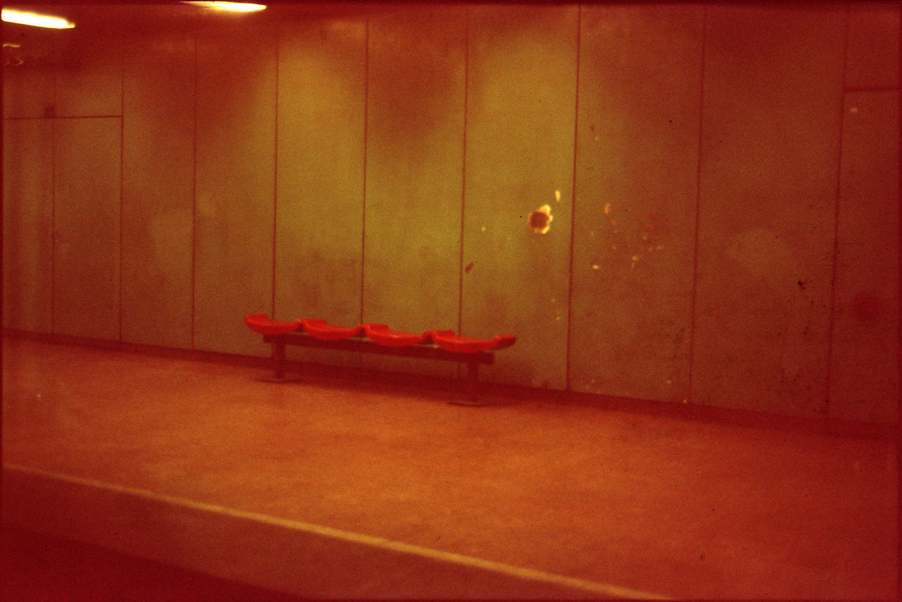 Empty seats against wall at railroad station platform