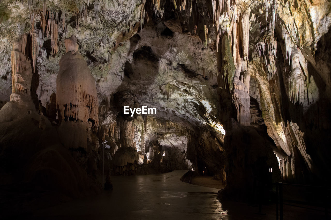 LOW ANGLE VIEW OF ROCK FORMATIONS AT CAVE