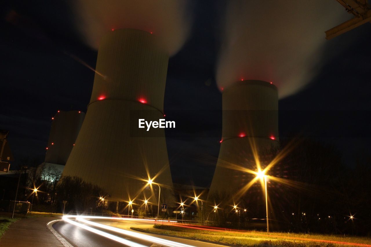 Low angle view of illuminated road against sky at night