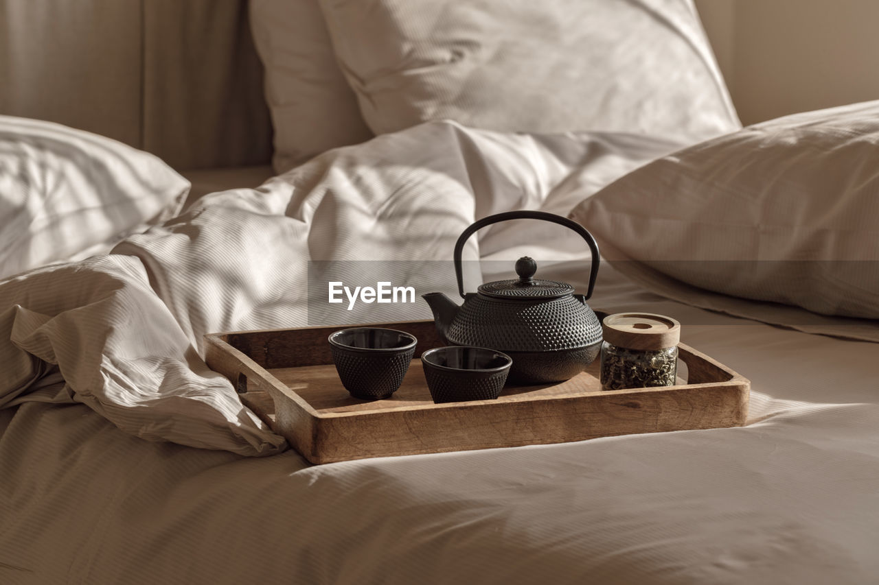 close-up of wedding rings on bed