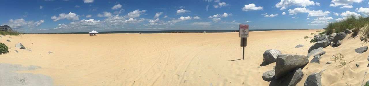 land, sand, sky, cloud - sky, beach, day, scenics - nature, nature, tranquil scene, sunlight, no people, desert, landscape, beauty in nature, tranquility, panoramic, water, horizon, outdoors, sand dune, arid climate, climate, wooden post