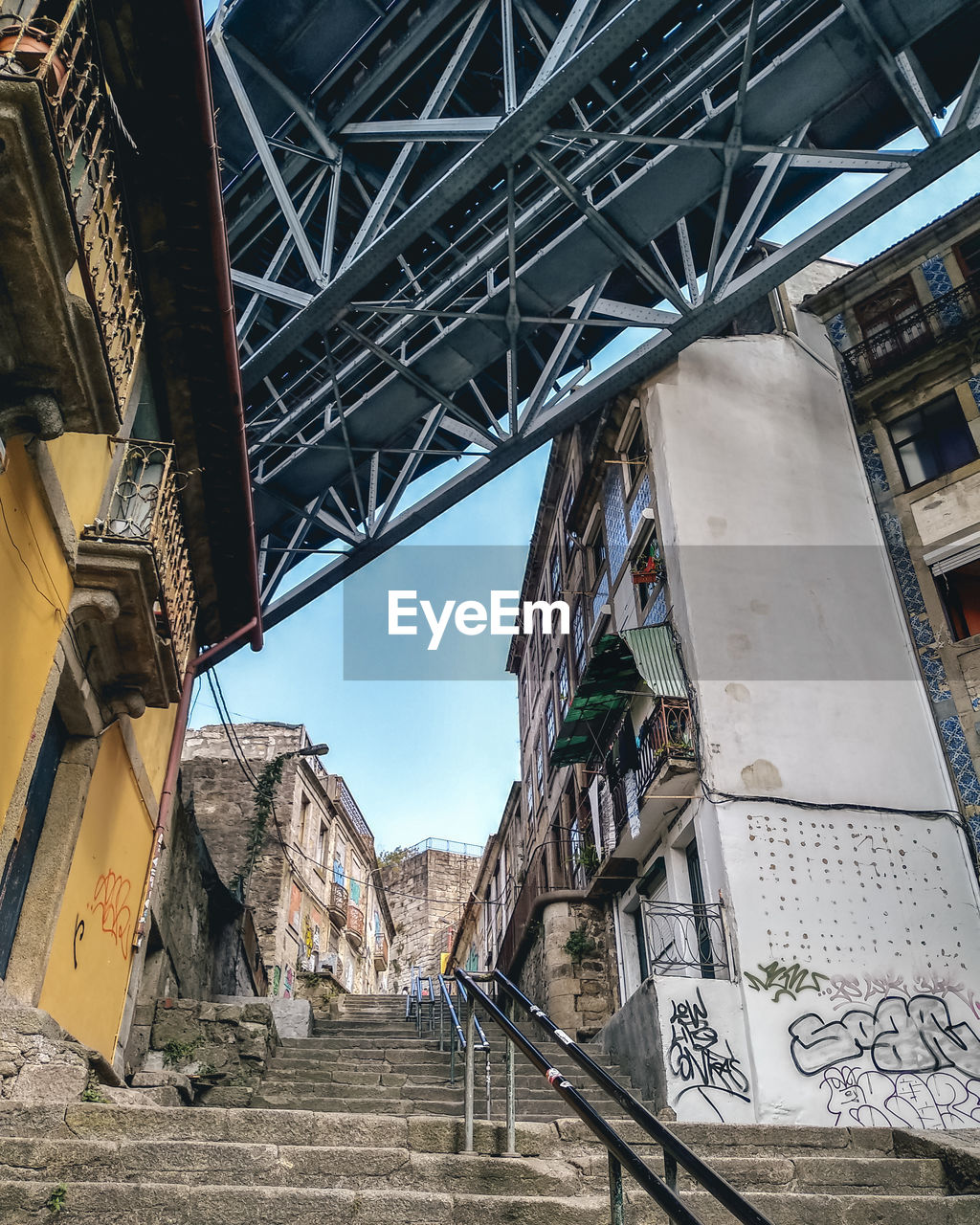 Low angle view of bridge and buildings against sky in porto 