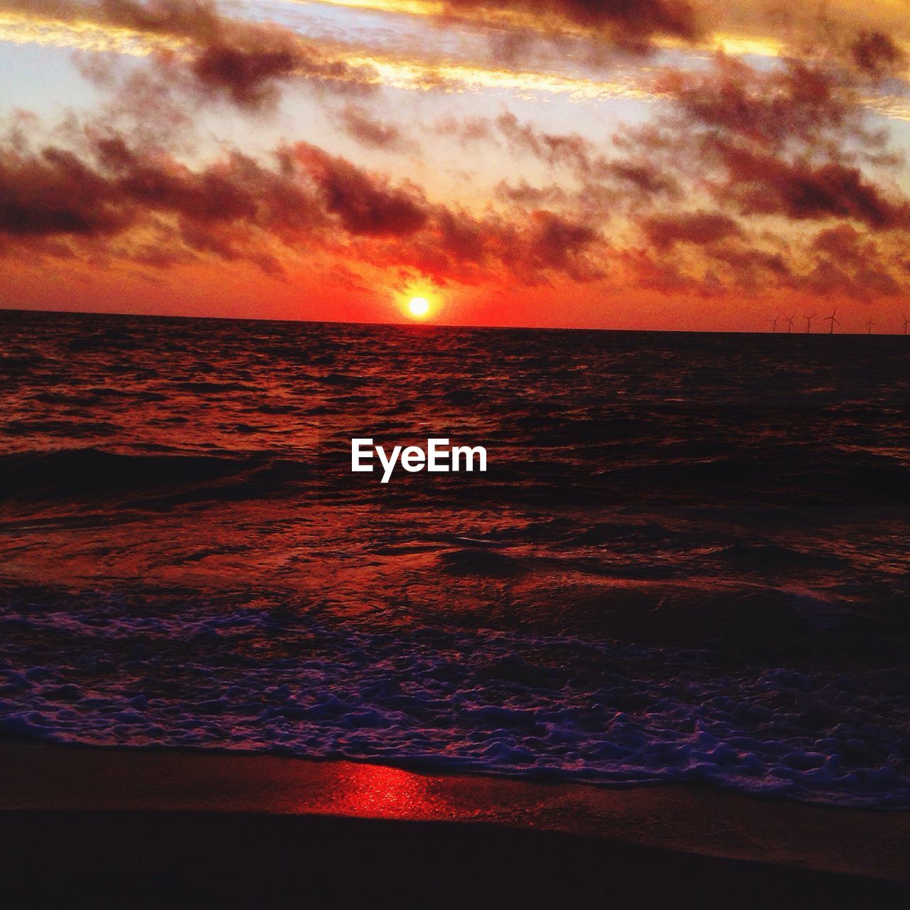 SCENIC VIEW OF BEACH AGAINST SKY DURING SUNSET