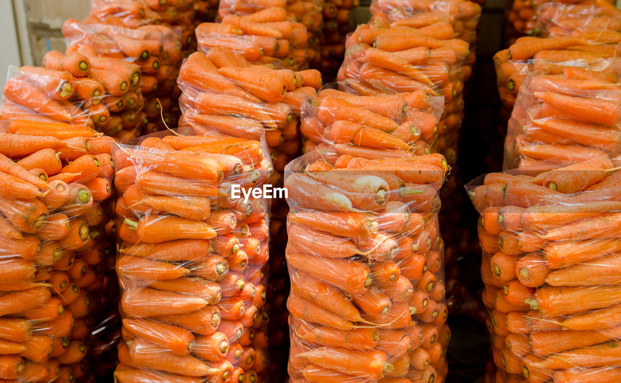 Bags with young fresh carrot prepared for sale. freshly harvested carrots. harvesting 