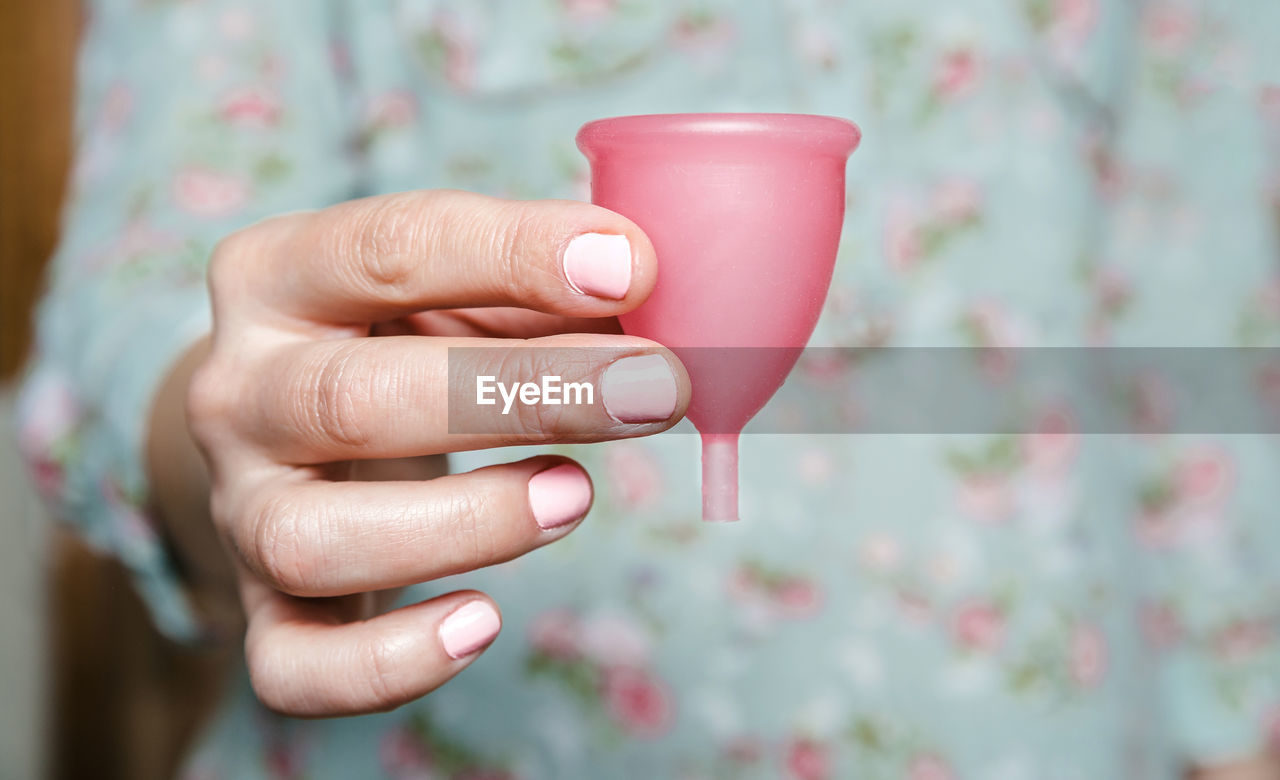 Midsection of woman holding menstrual cup