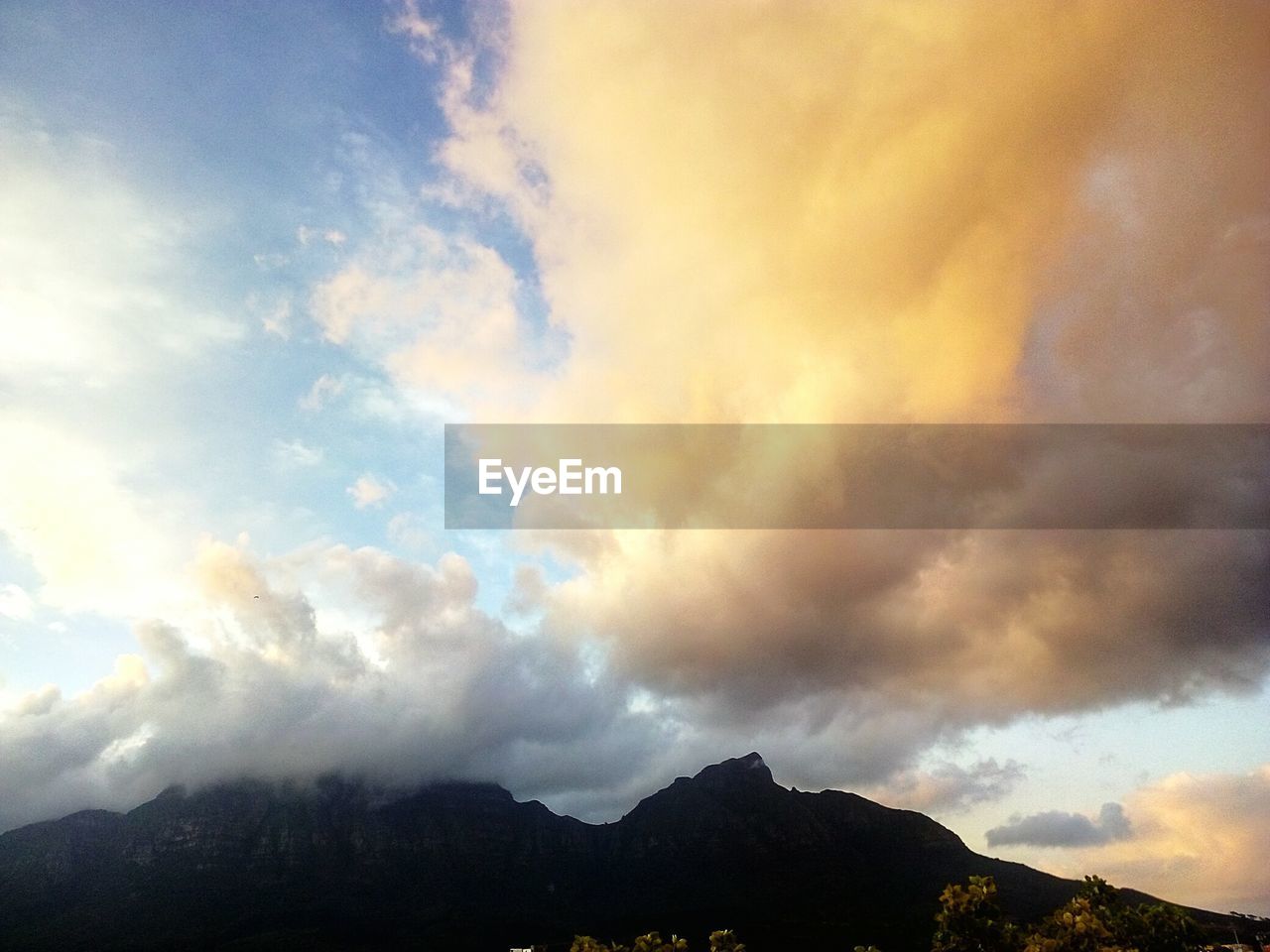 SCENIC VIEW OF CLOUDS OVER MOUNTAINS AGAINST SKY