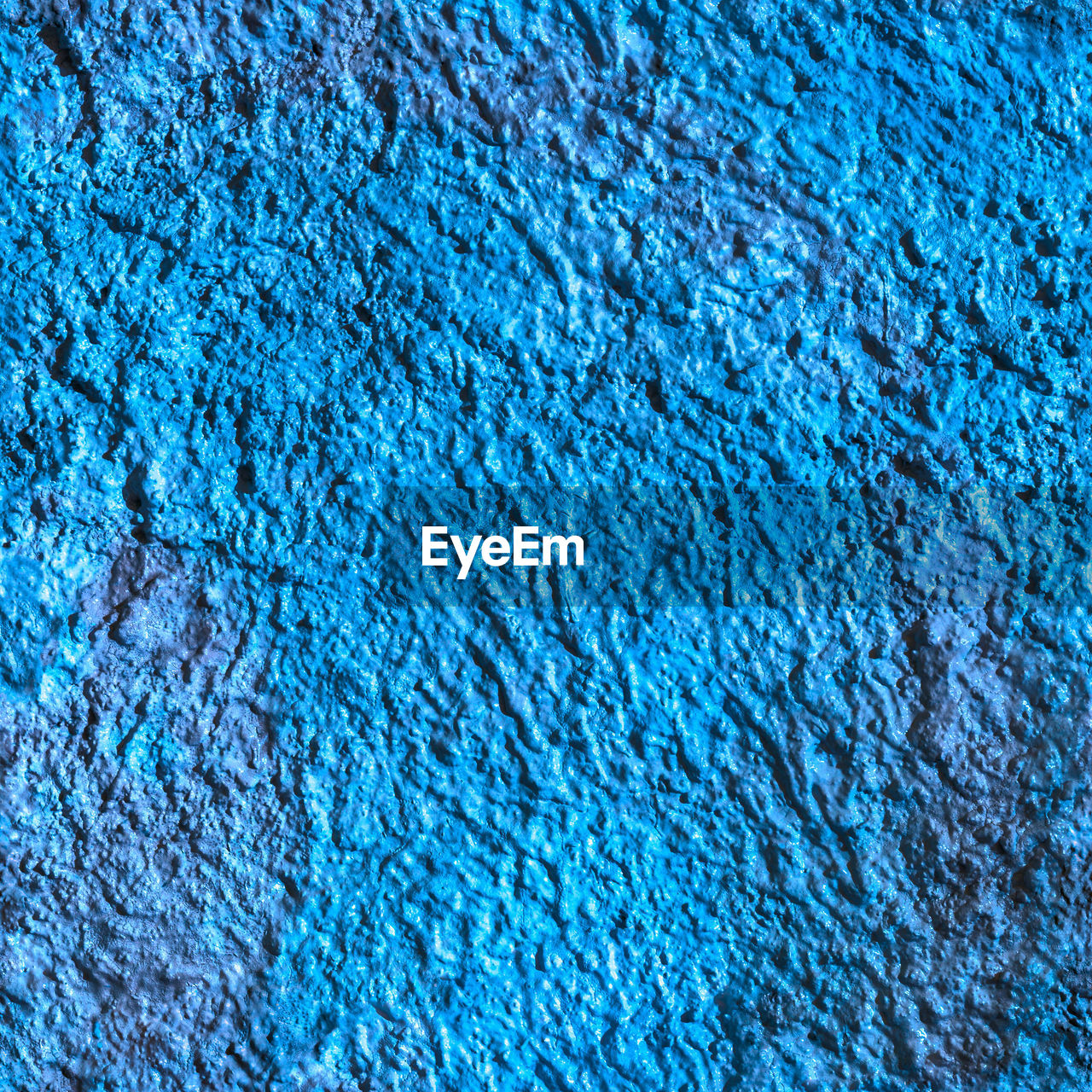 Full frame background and texture of blue decorative plaster on outside wall of the building