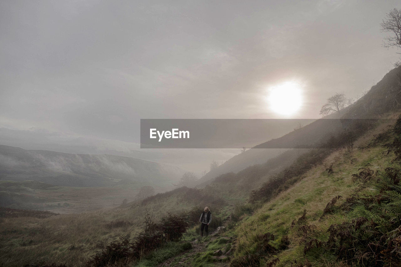 Scenic view of mountains against cloudy sky