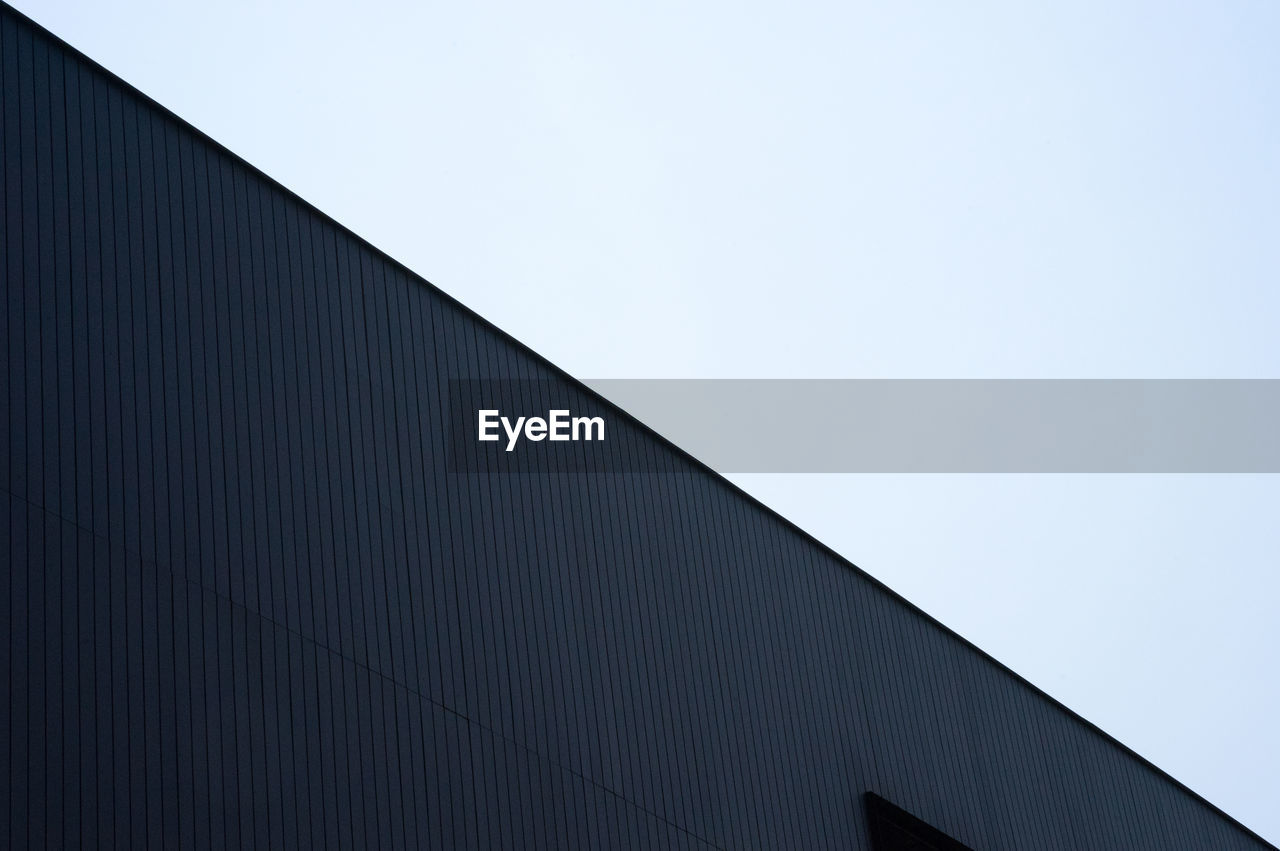 Low angle view of modern building against clear sky