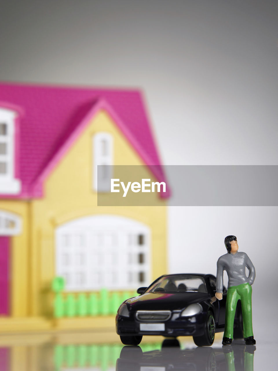 Close-up of toy car against toy house