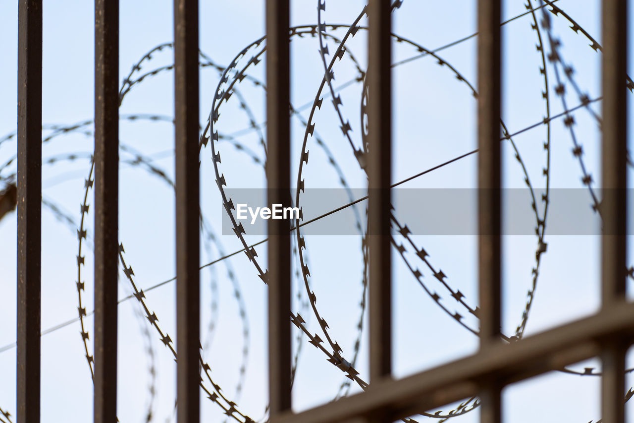 Barbed wire on prison fence. restricted access from restricted area. security guard