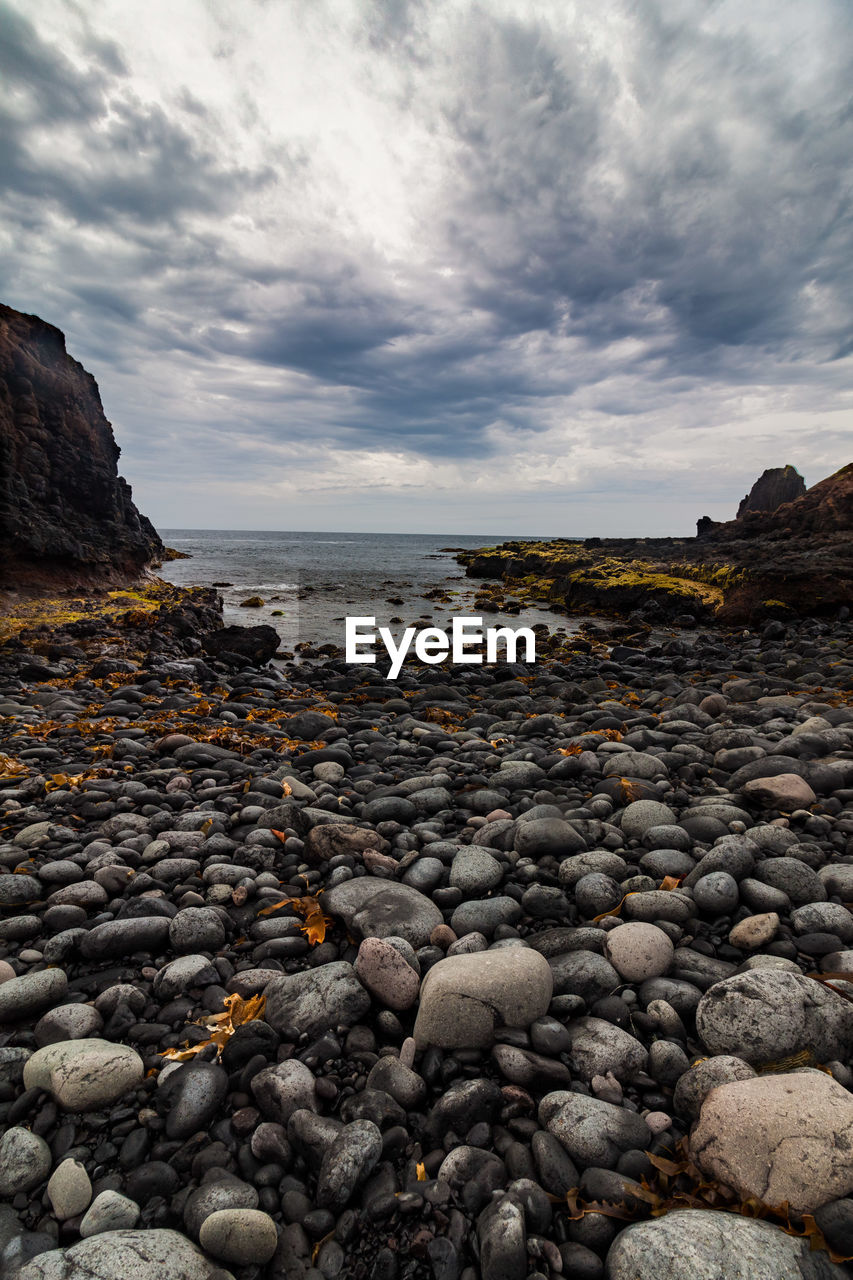 Rocks on beach against sky