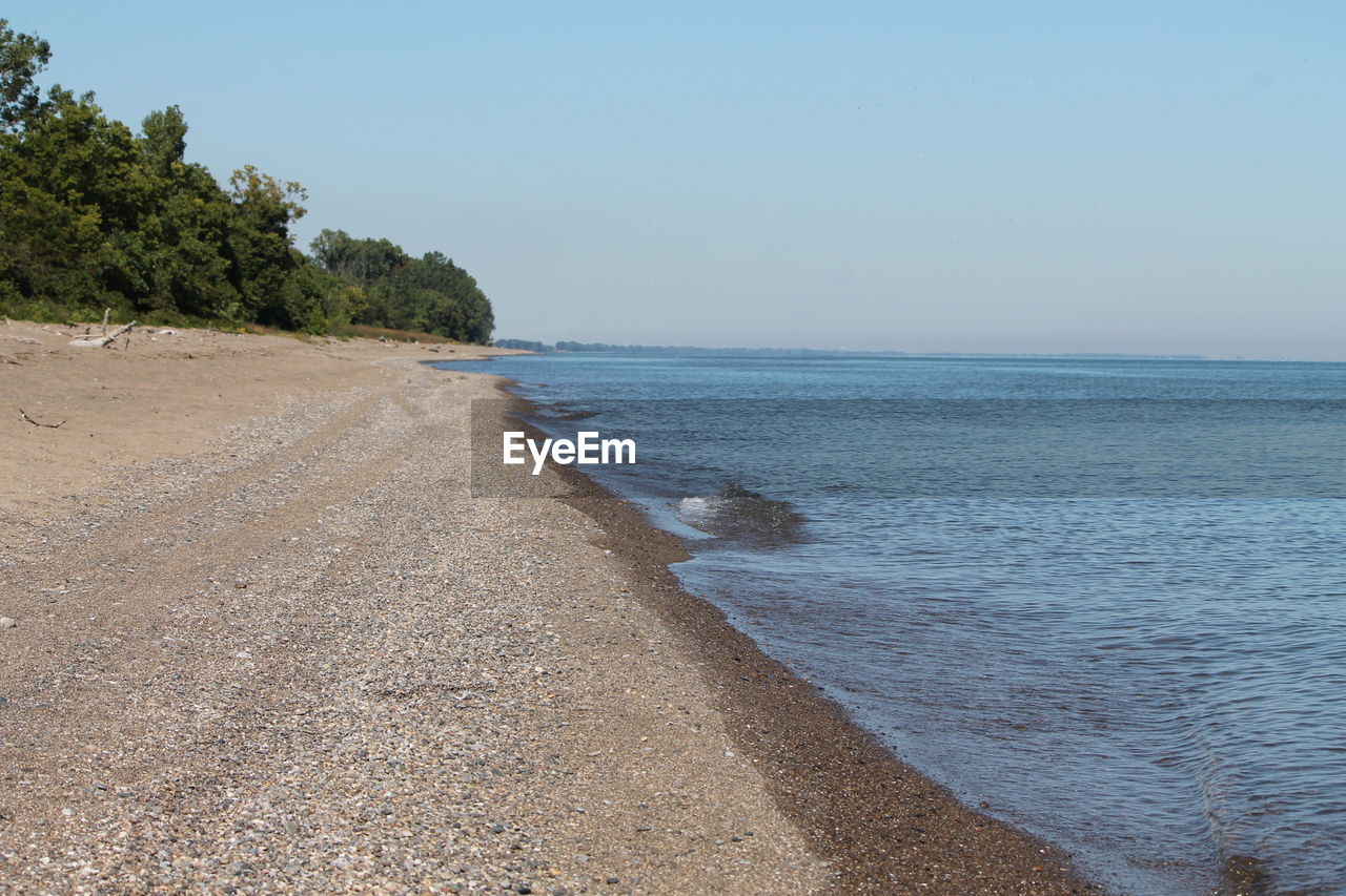 VIEW OF CALM BEACH AGAINST THE SKY