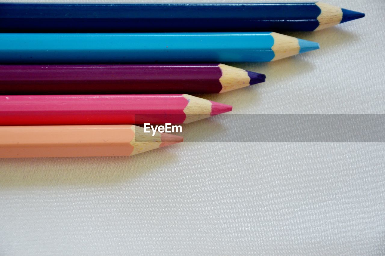 Colored pencils against white background