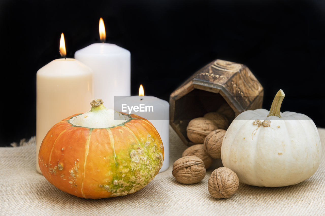 CLOSE-UP OF CANDLES ON TABLE