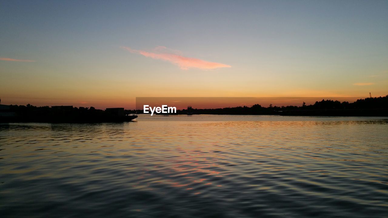 SCENIC VIEW OF SUNSET OVER SEA