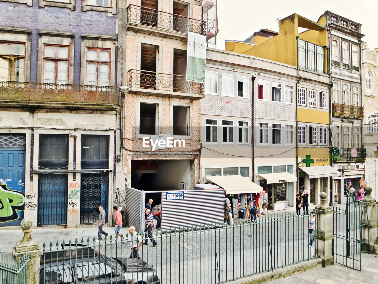 PEOPLE ON STREET AGAINST BUILDINGS