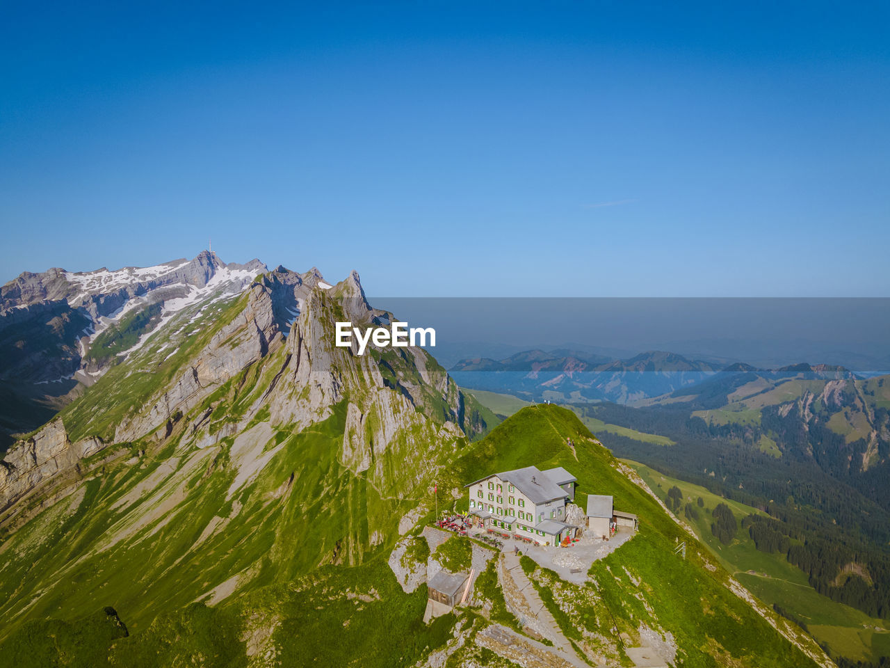 HIGH ANGLE VIEW OF MOUNTAIN RANGE AGAINST BLUE SKY