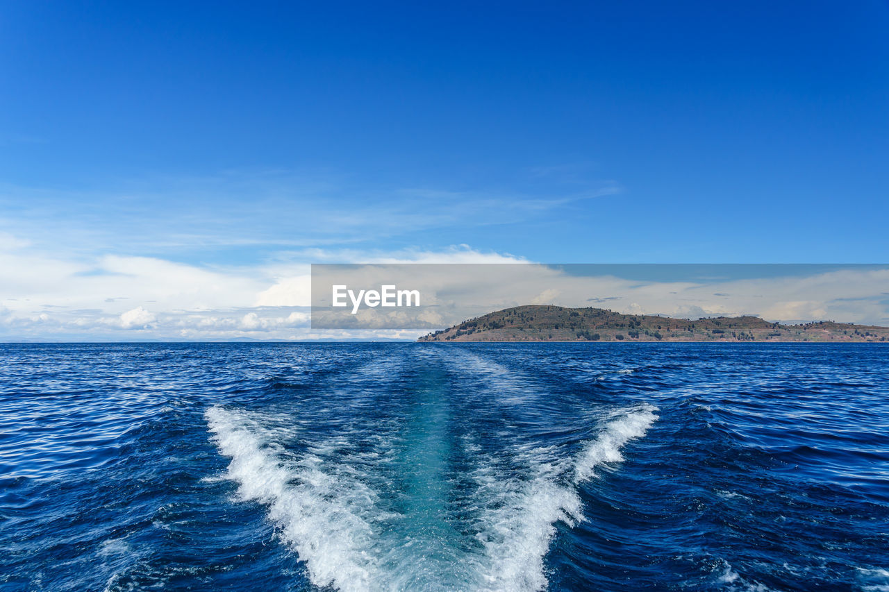 Scenic view of sea against blue sky