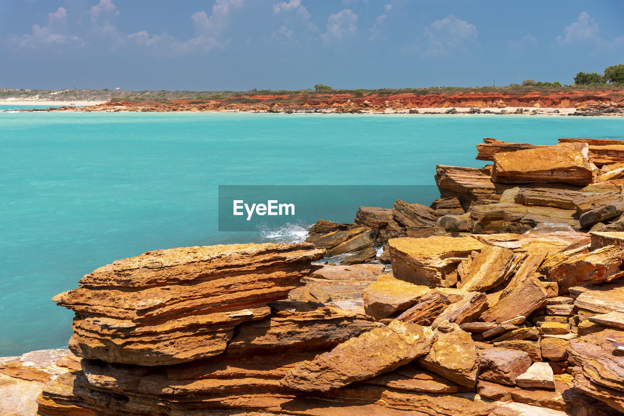 Stack of rocks on beach against sky