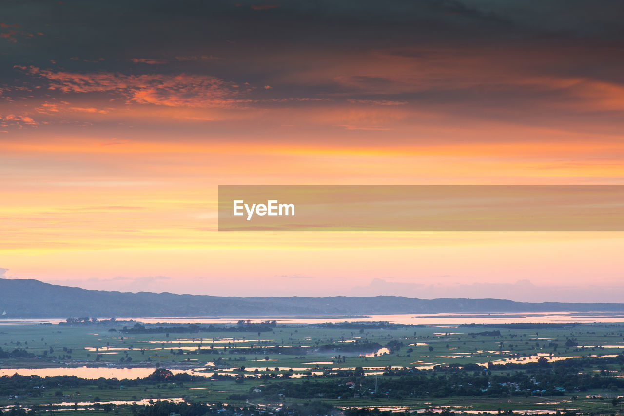 Scenic view of landscape against sky during sunset
