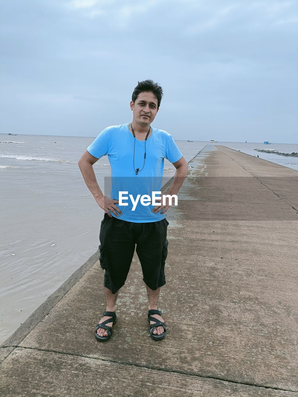 FULL LENGTH OF MAN STANDING ON BEACH