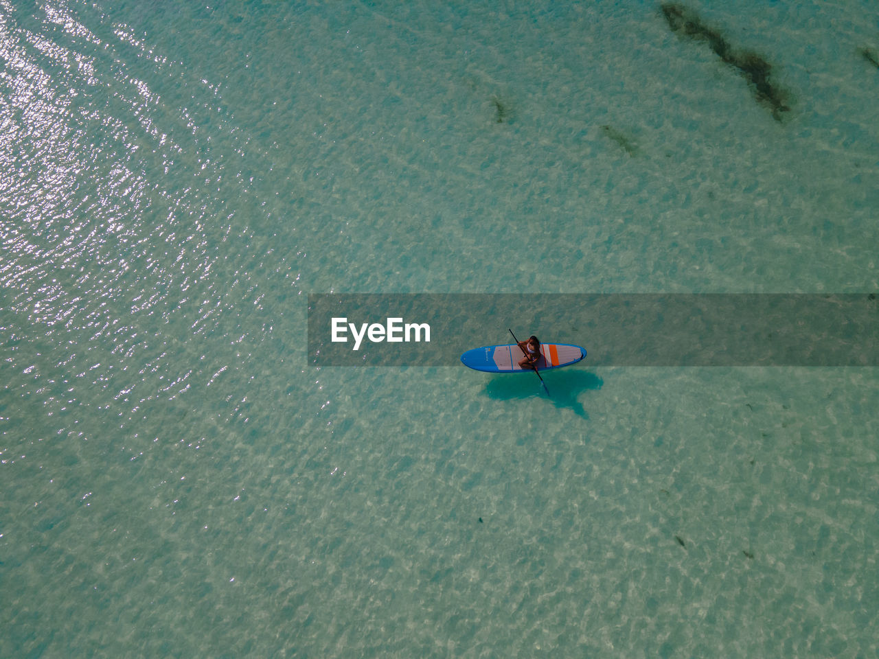 high angle view of people kayaking in sea