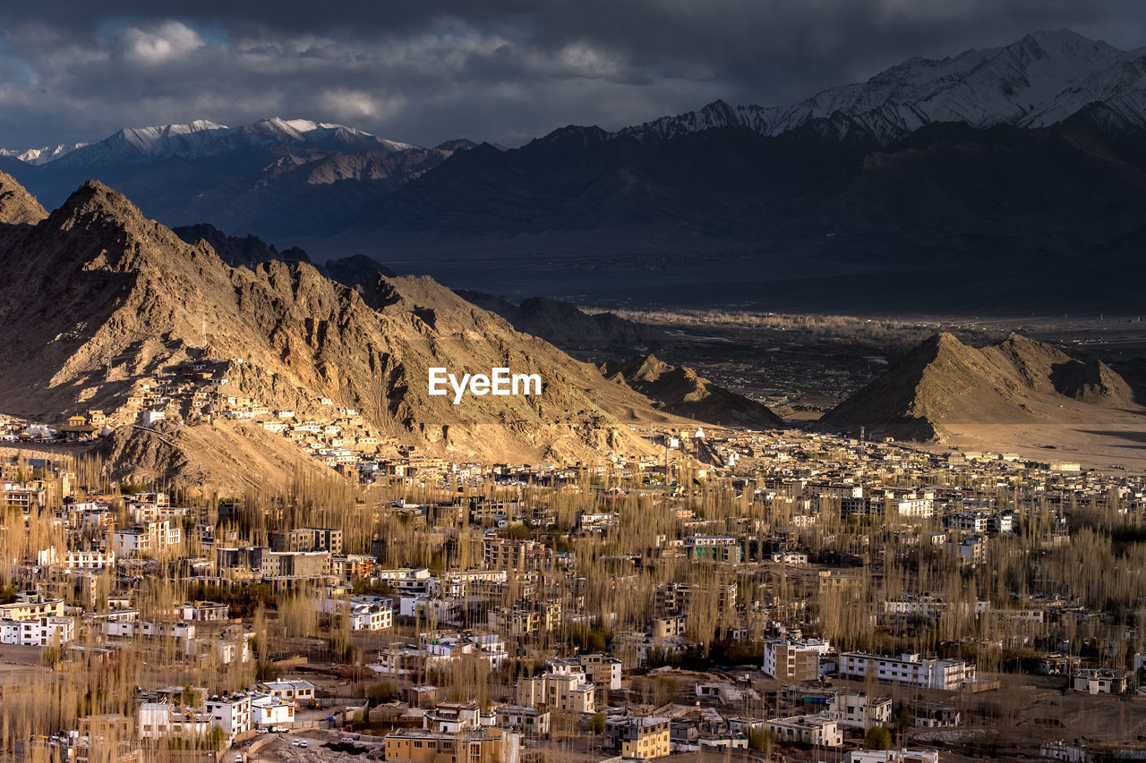 High angle view of townscape and mountains against sky