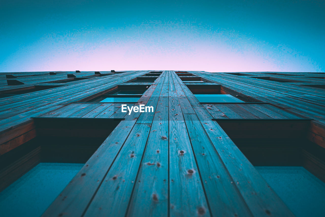 Low angle view of building against clear blue sky