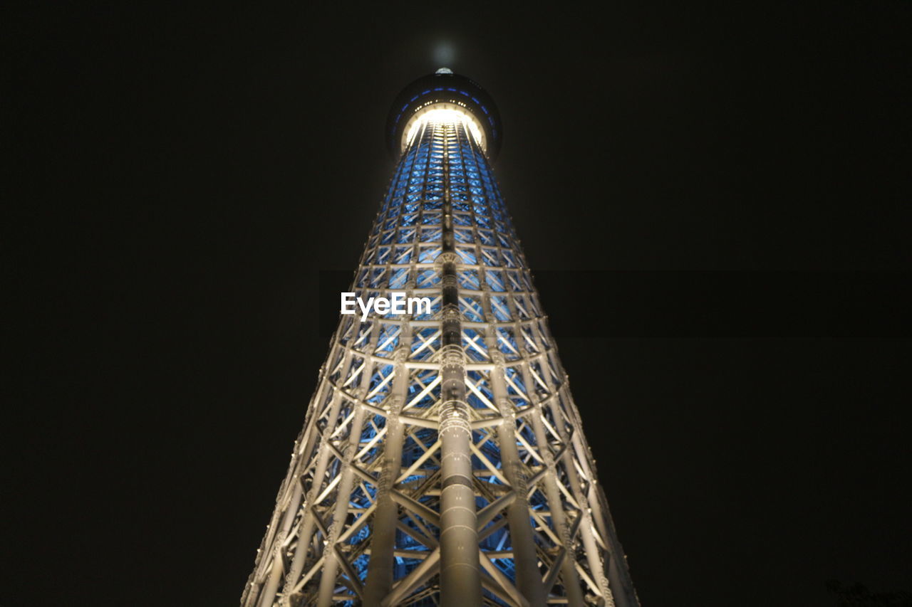 LOW ANGLE VIEW OF ILLUMINATED TOWER AGAINST SKY