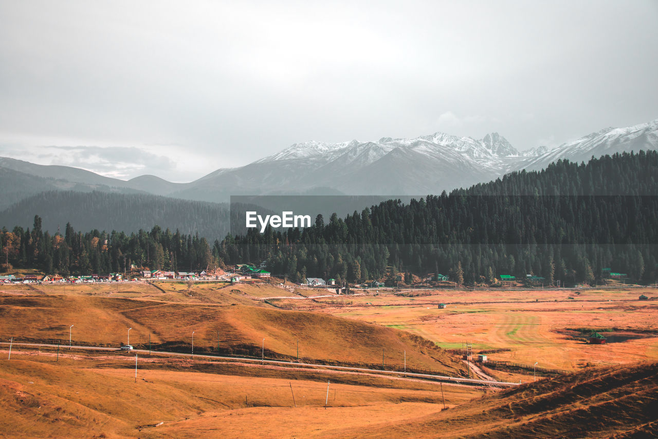 Scenic view of landscape and mountains against sky