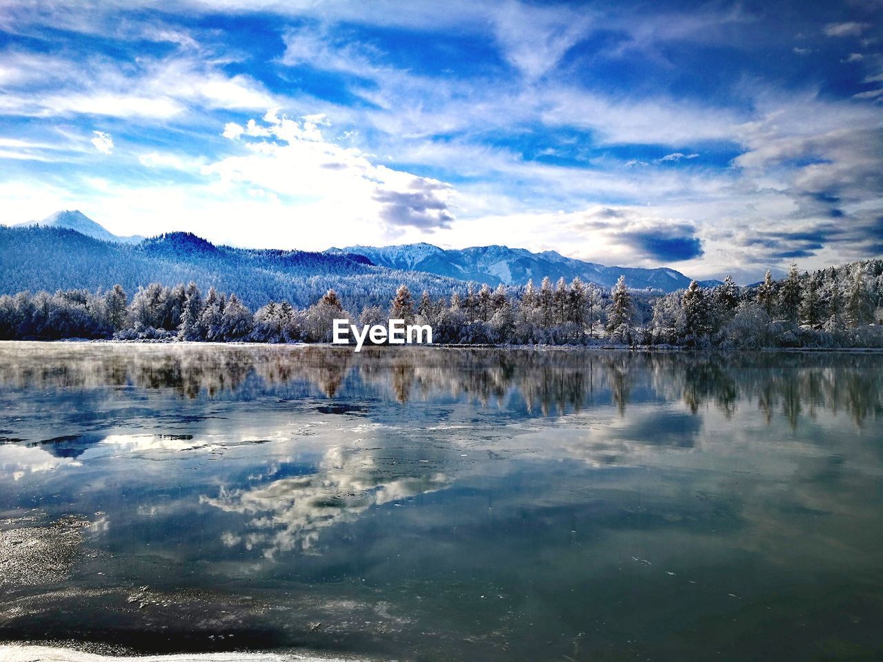 SCENIC VIEW OF LAKE BY SNOW COVERED LANDSCAPE