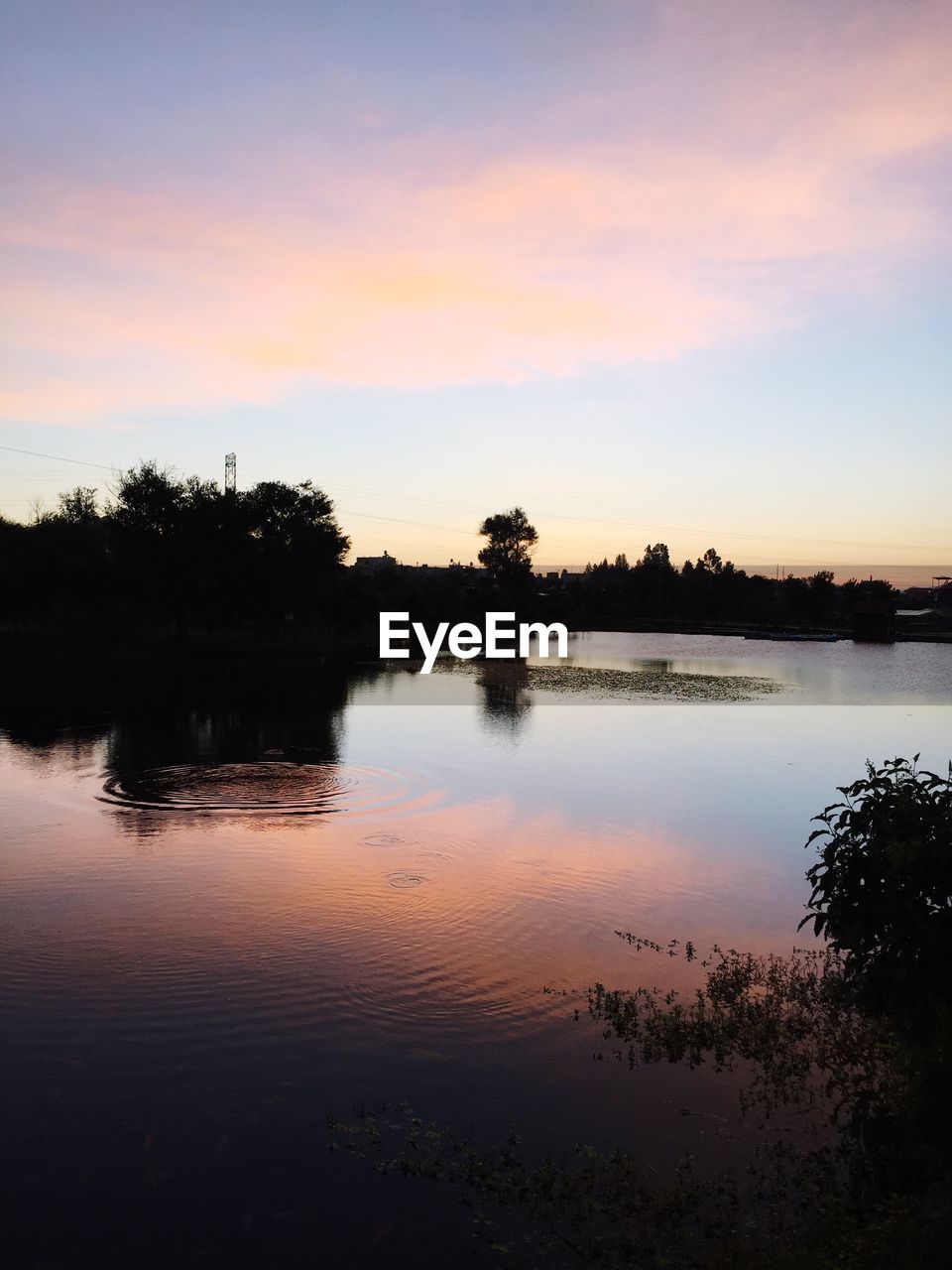SCENIC VIEW OF LAKE AGAINST ORANGE SKY