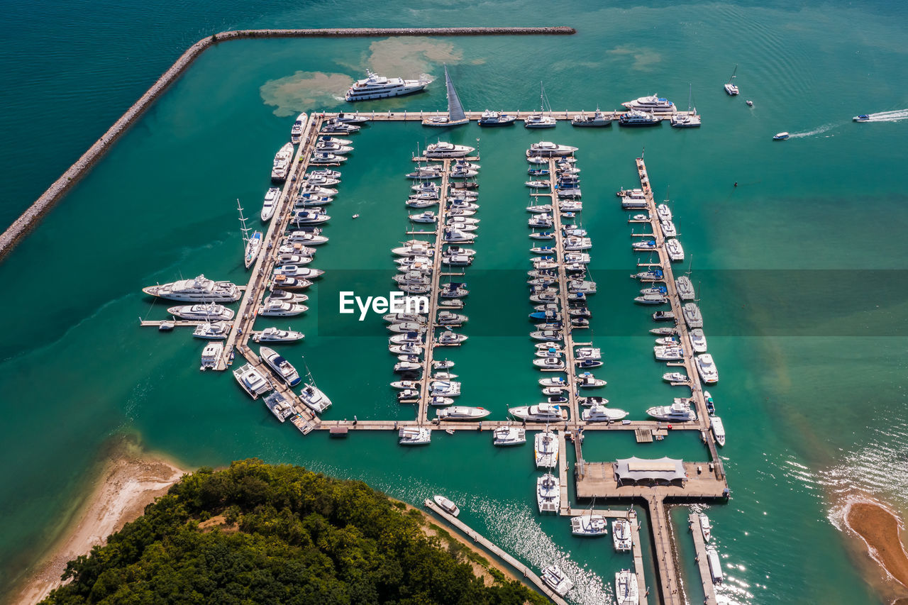 Yachts and boats in marina bay at phuket thailand aerial view