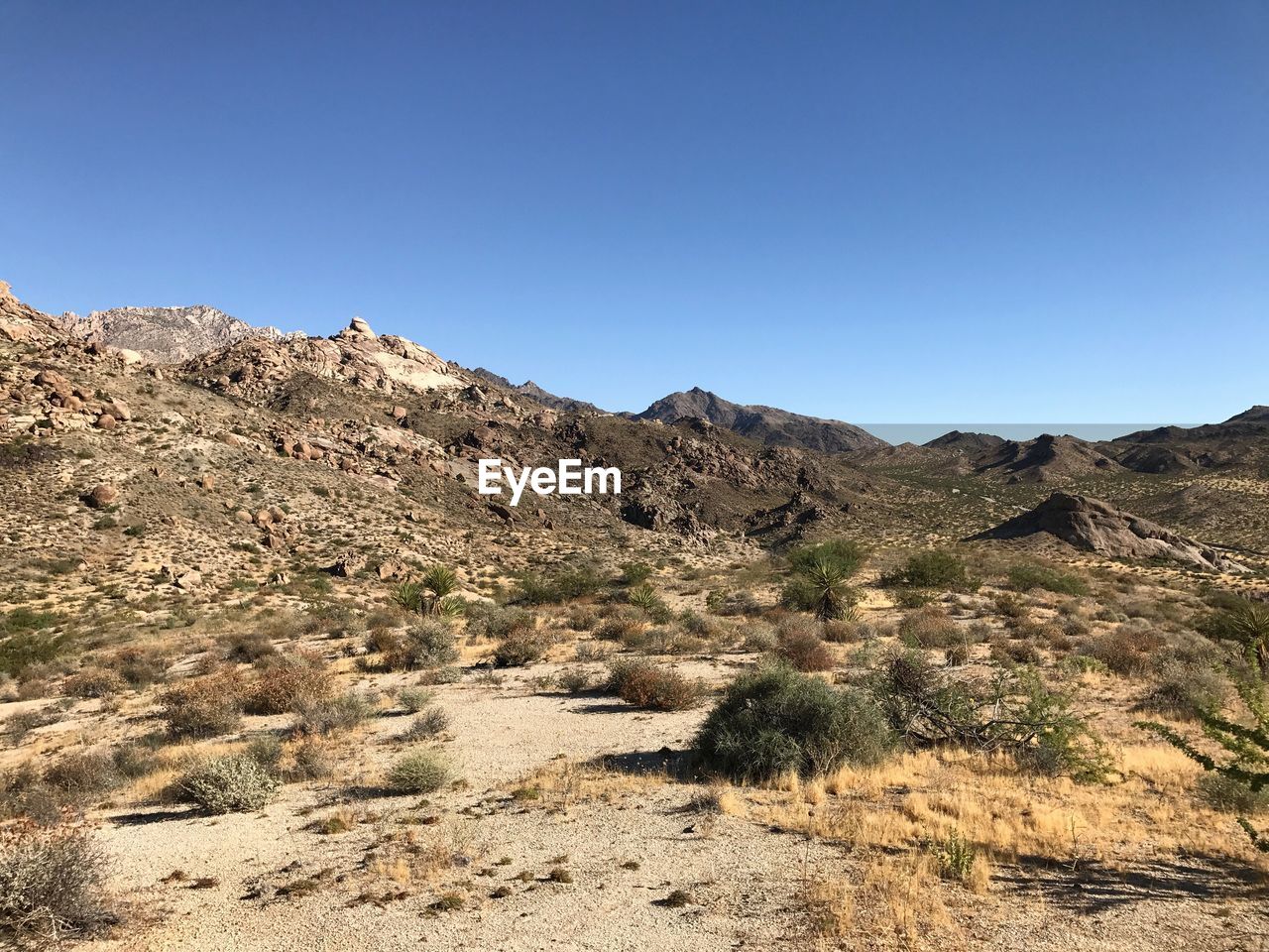 Scenic view of mountain against clear blue sky